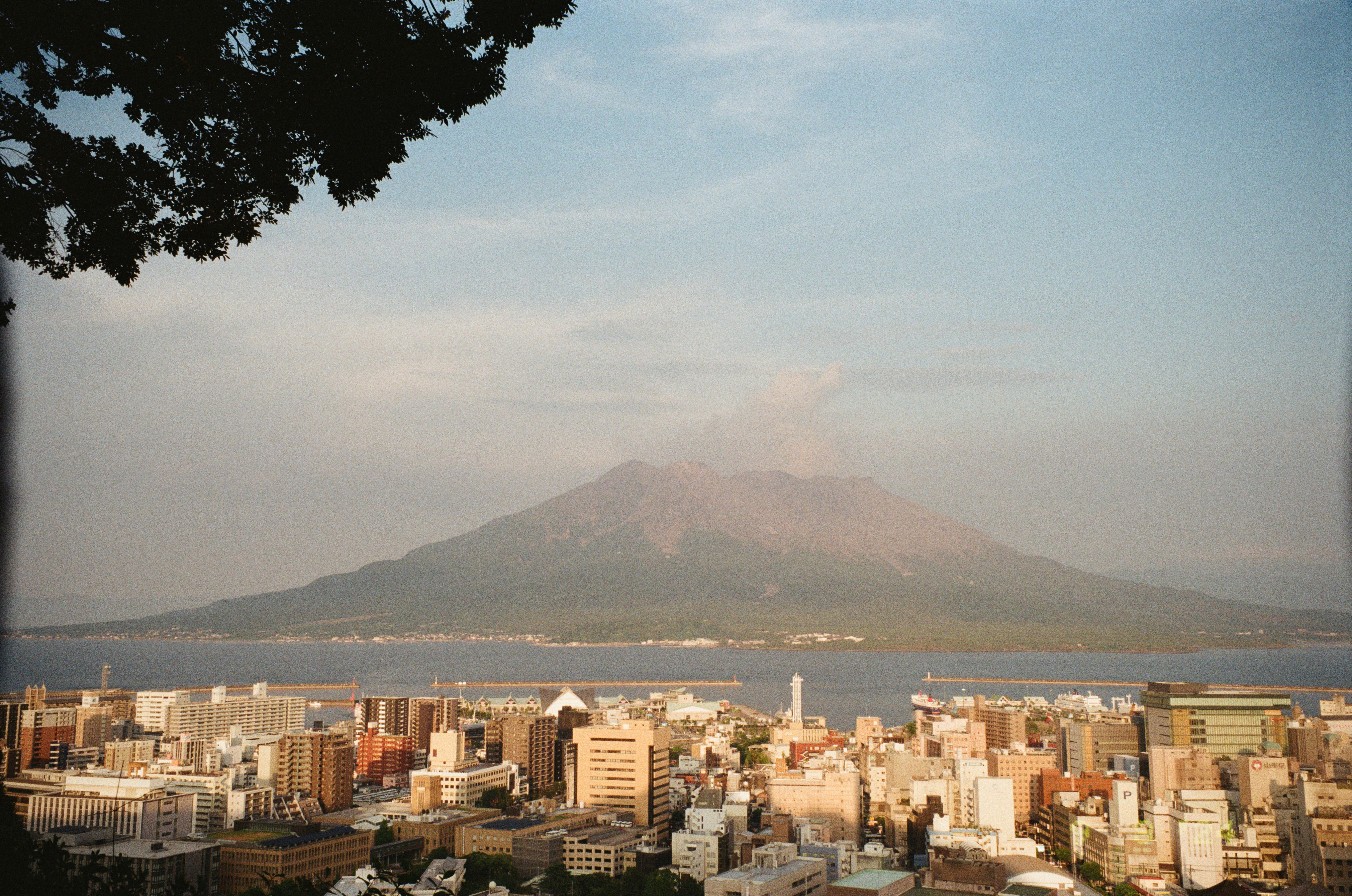 Dramatic view of Kagoshima cityscape with Sakurajima volcano in Japan.