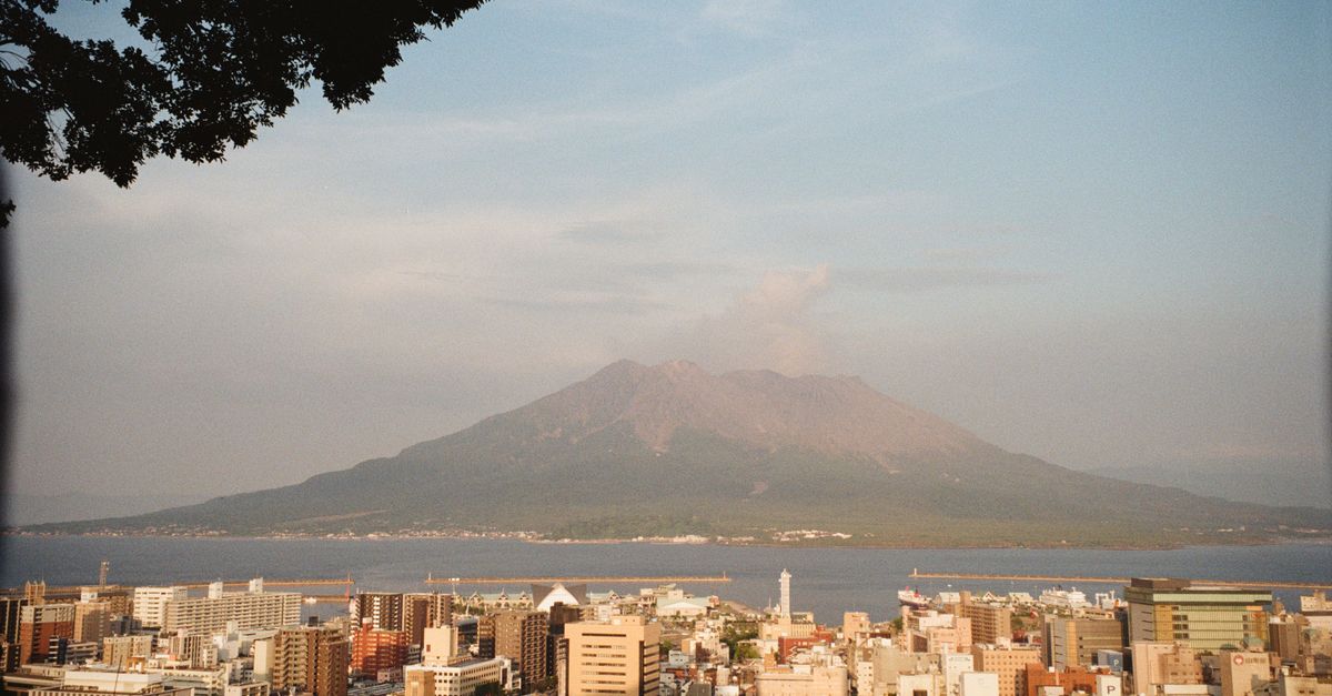 Dramatic view of Kagoshima cityscape with Sakurajima volcano in Japan.