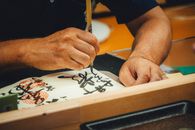 A close-up of an artist skillfully creating Japanese calligraphy with a brush.