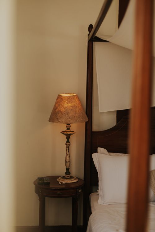Free Elegant bedroom featuring a vintage lamp and classic wooden furniture in Ouro Preto, Brazil. Stock Photo