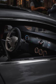 A close-up of a luxury car's digital dashboard and stylish interior.