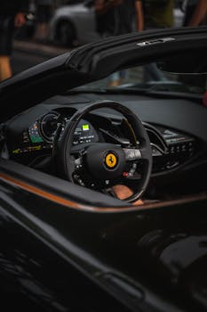 Close-up of steering wheel and dashboard of an exotic luxury sports car with elegant design.