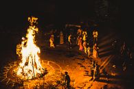 Captivating night scene of a traditional Indian fire ritual with people gathered around.