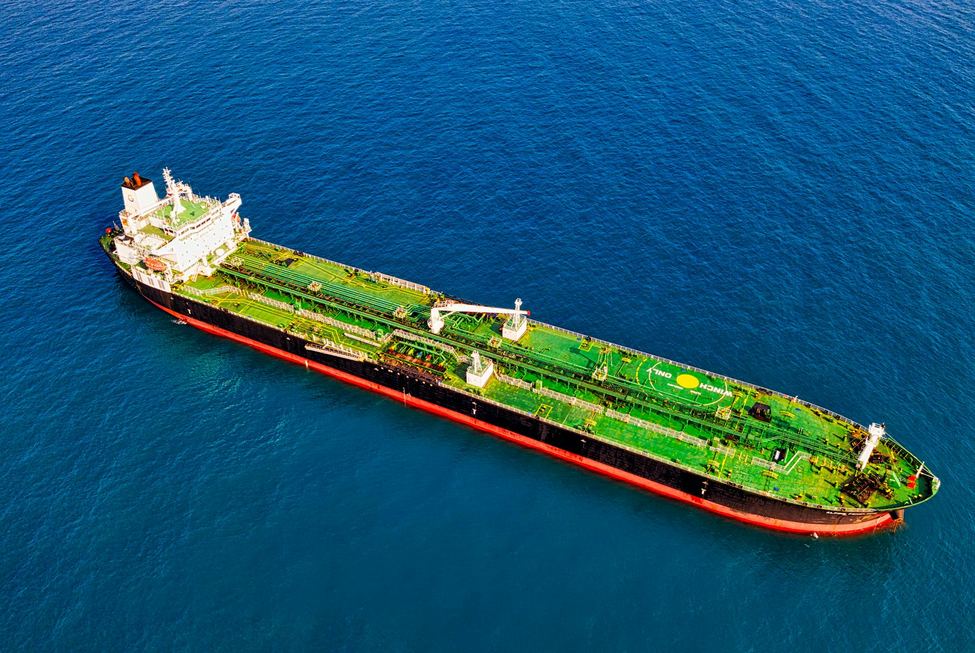 Aerial shot of a cargo ship cruising in the blue waters of Banten, Indonesia.