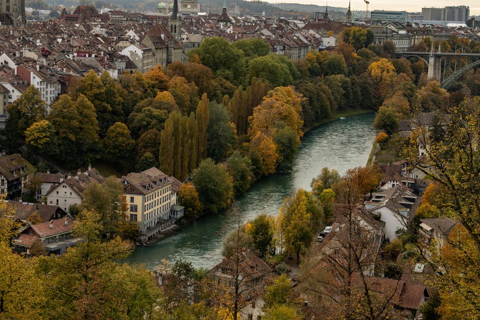 A beautiful autumn view of Bern, Switzerland, showcasing vibrant fall foliage and historic architecture.