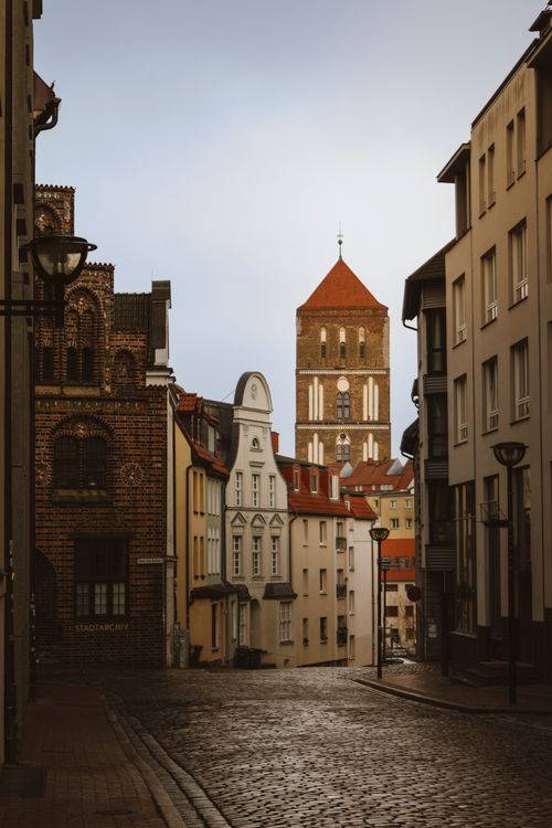 Free View of historical buildings and cobblestone streets in Rostock, Germany. Stock Photo