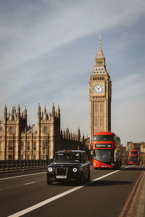 Free Classic view of Big Ben with London red buses on Westminster Bridge. Stock Photo
