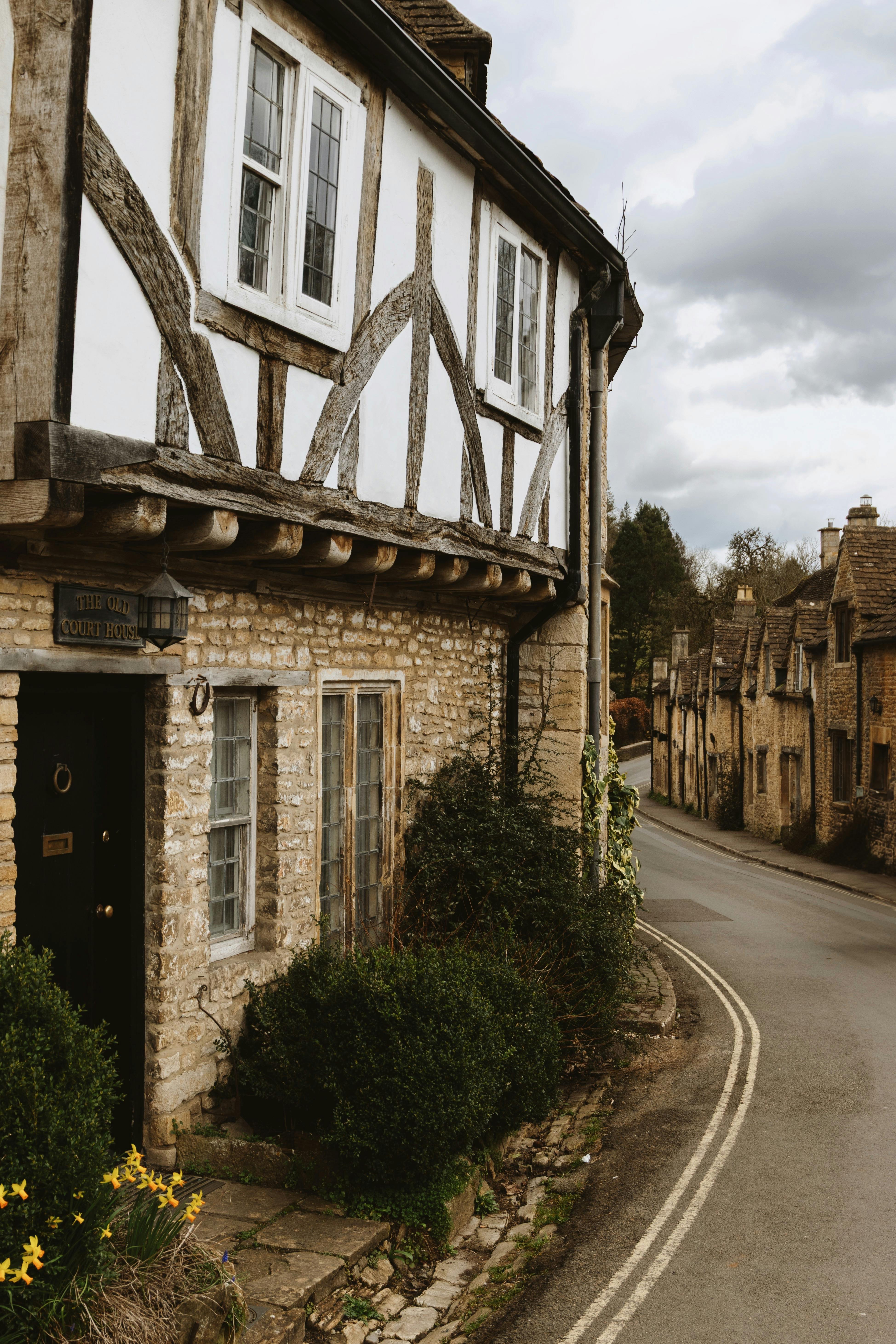 Quaint village street in the Cotswolds, showcasing historic architecture and serene surroundings.