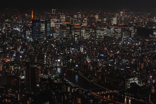 A captivating aerial view of Tokyo's illuminated cityscape at night, showcasing the vibrant urban life.