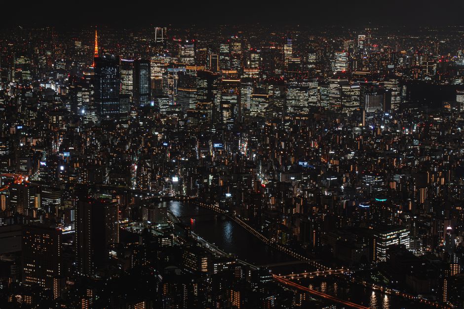 A captivating aerial view of Tokyo's illuminated cityscape at night, showcasing the vibrant urban life.