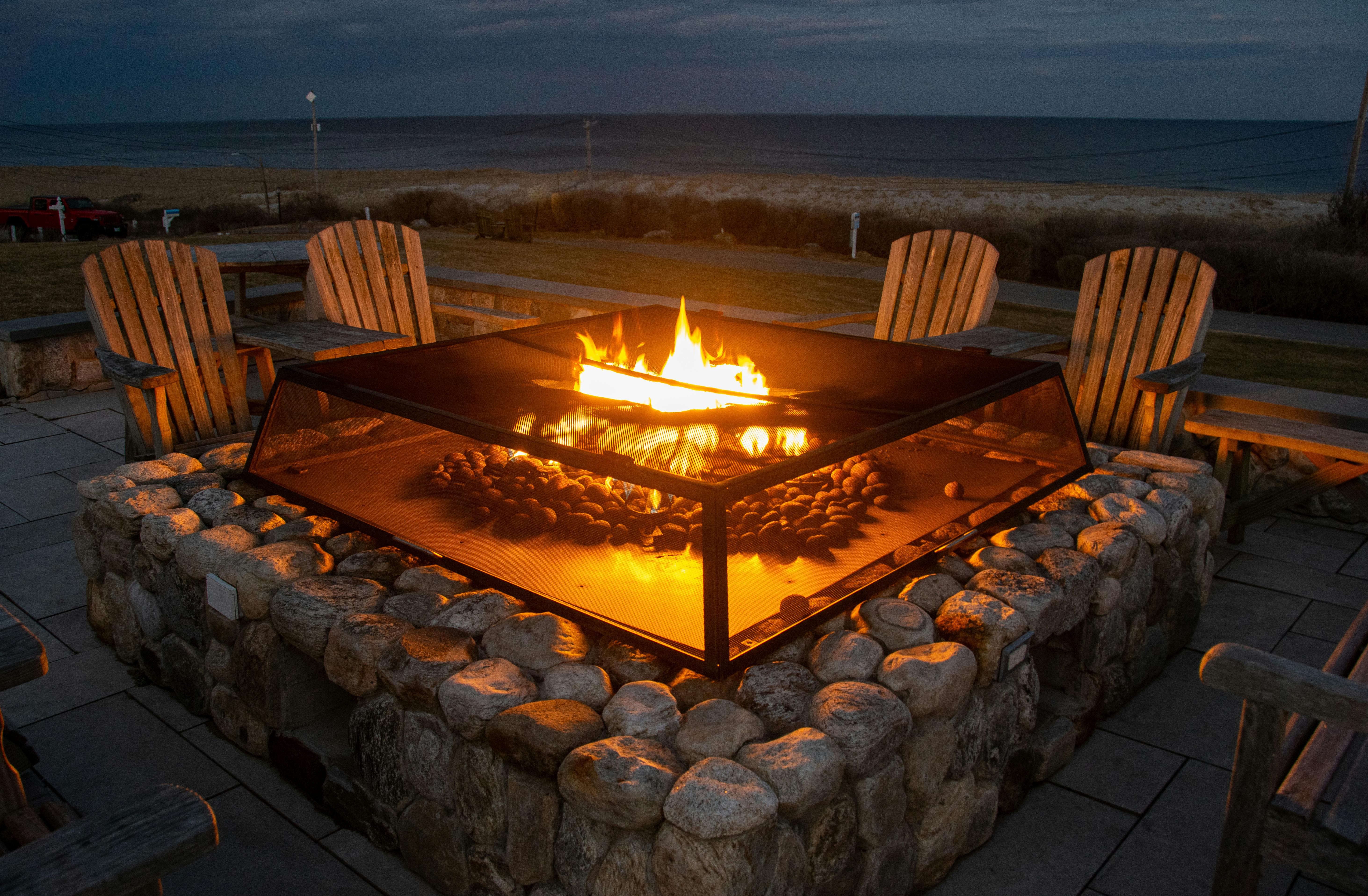 paver patio with circular fire pit as focal point - Paver patio design ideas