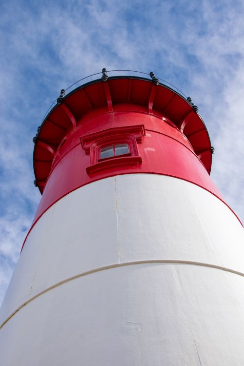 Free Low angle view of the iconic red and white Nauset Lighthouse in Eastham, Massachusetts under a bright blue sky. Stock Photo