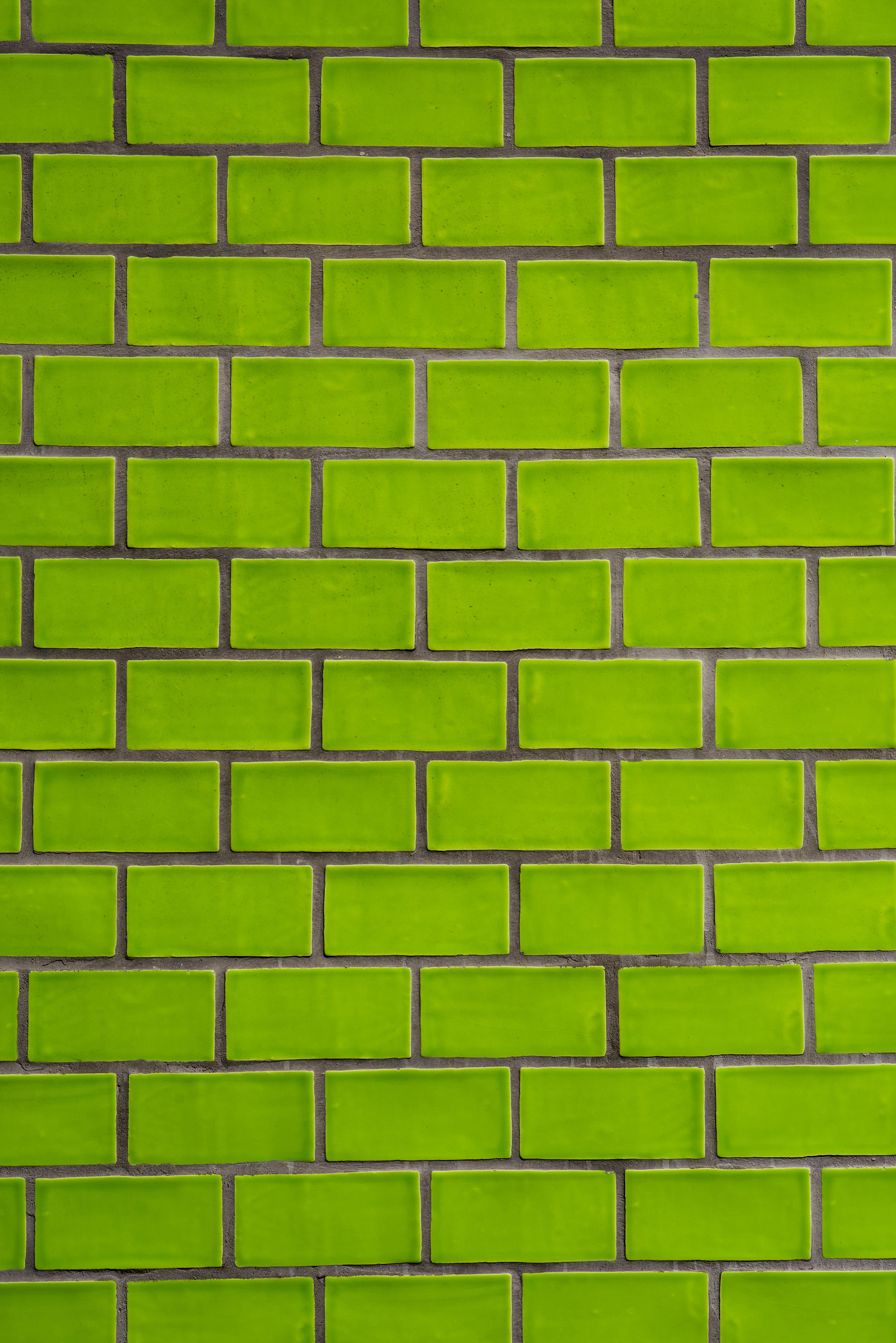 Bright green brick wall texture useful for backgrounds and design projects.