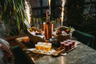 A festive setup featuring champagne, cocktails, and sparklers on a luxurious table.