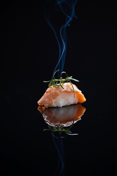 Elegant smoked salmon nigiri sushi with a smoky aroma and a perfect reflection.