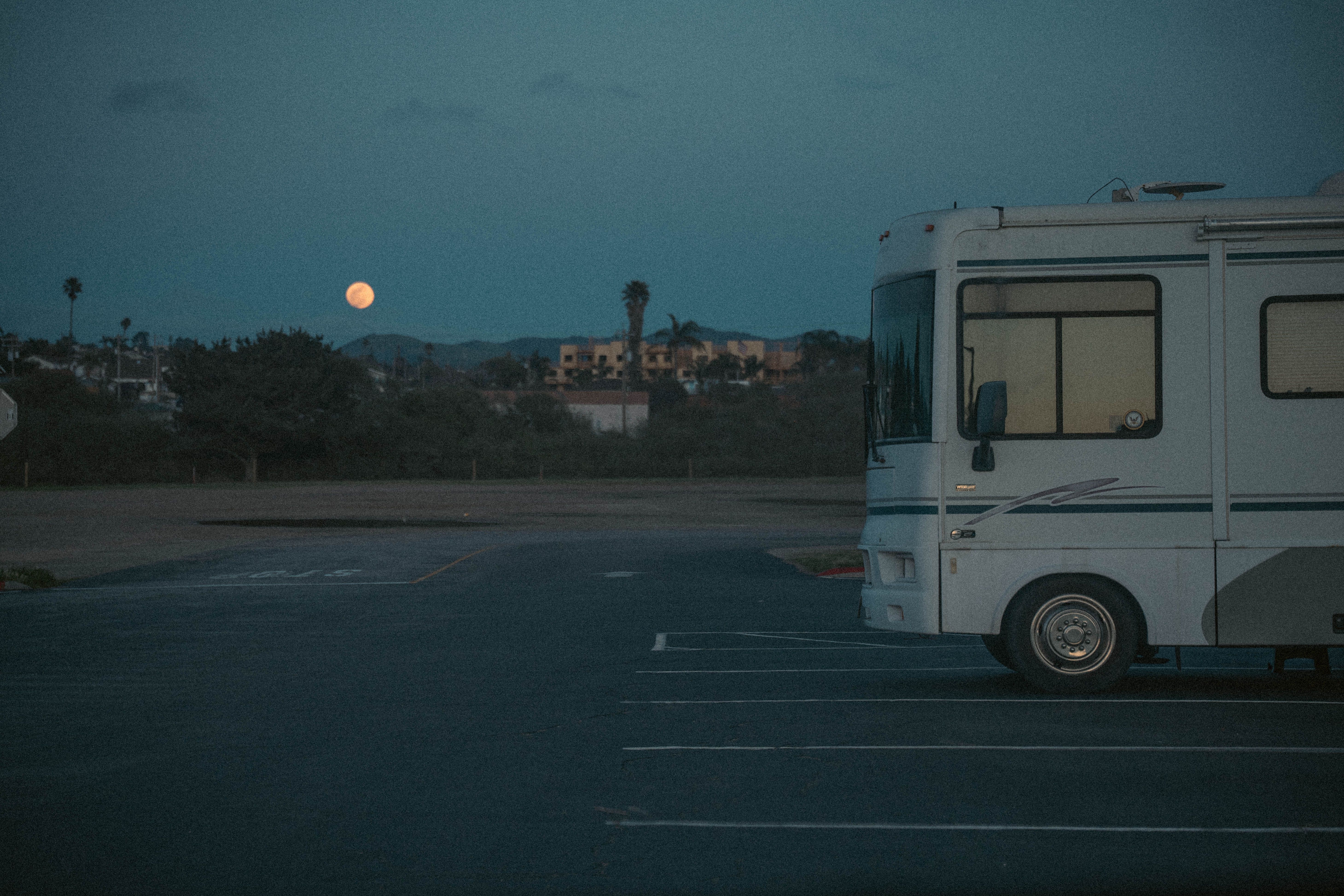 RV parked lawfully on a residential street during sunset
