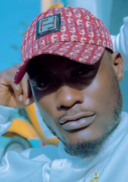 Man Wearing Red and Beige Fendi Baseball Cap