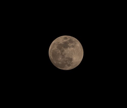 Free High-resolution photo of the full moon set against a black night sky, highlighting its detailed surface. Stock Photo