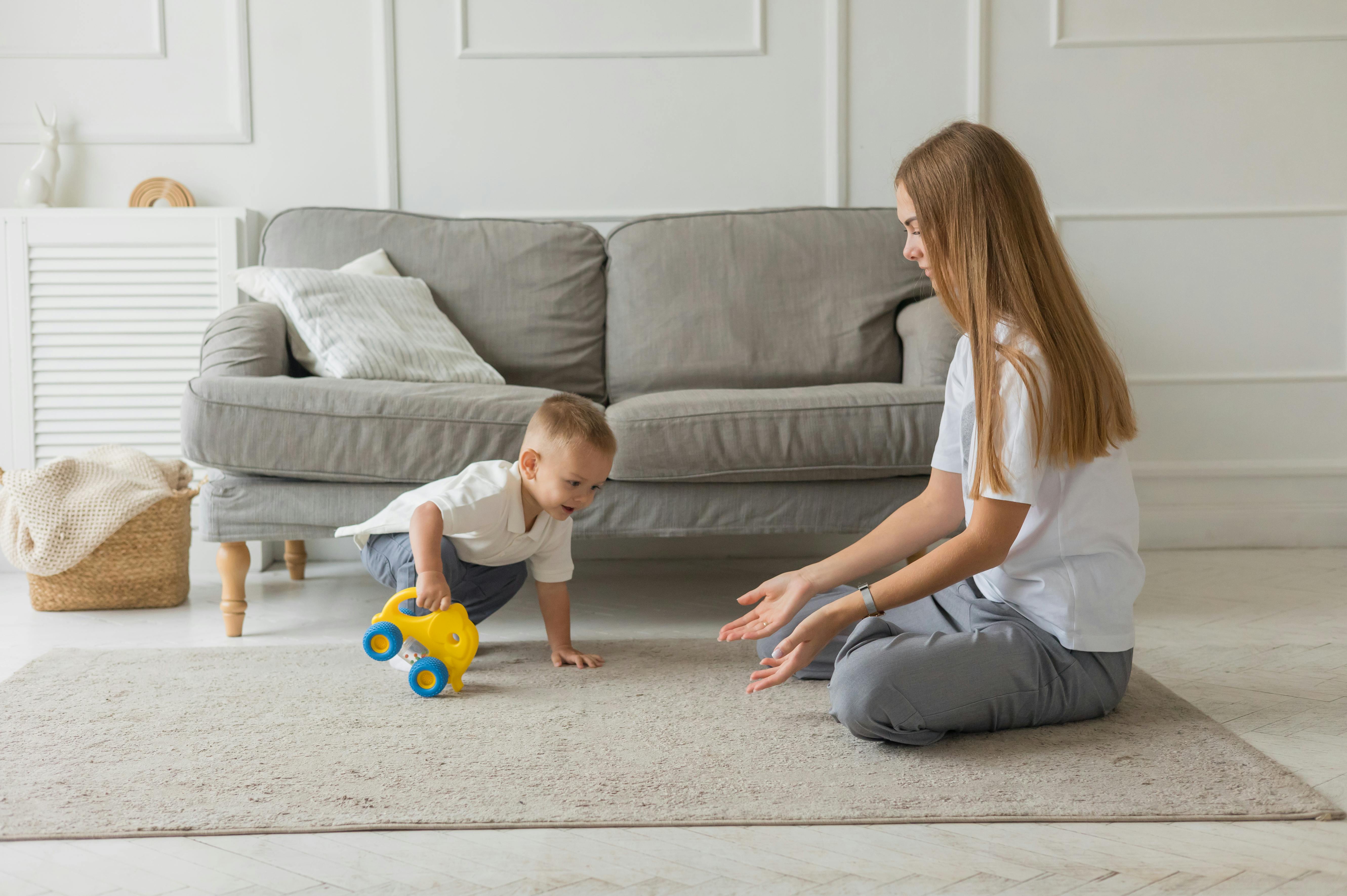 Child Expressing Anger In A Cozy Living Room Setting, With Toys Scattered Around And A Parent Listening Empathetically