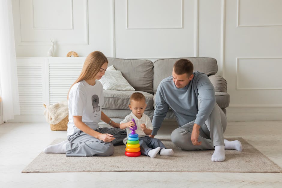 Mom, dad, and young child playing with colorful stacking toy in cozy living room setting.