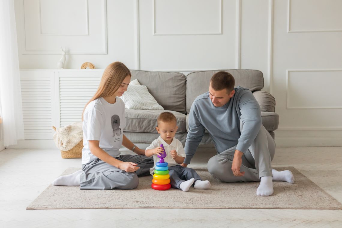 Family enjoying an educational stacking toy together at home