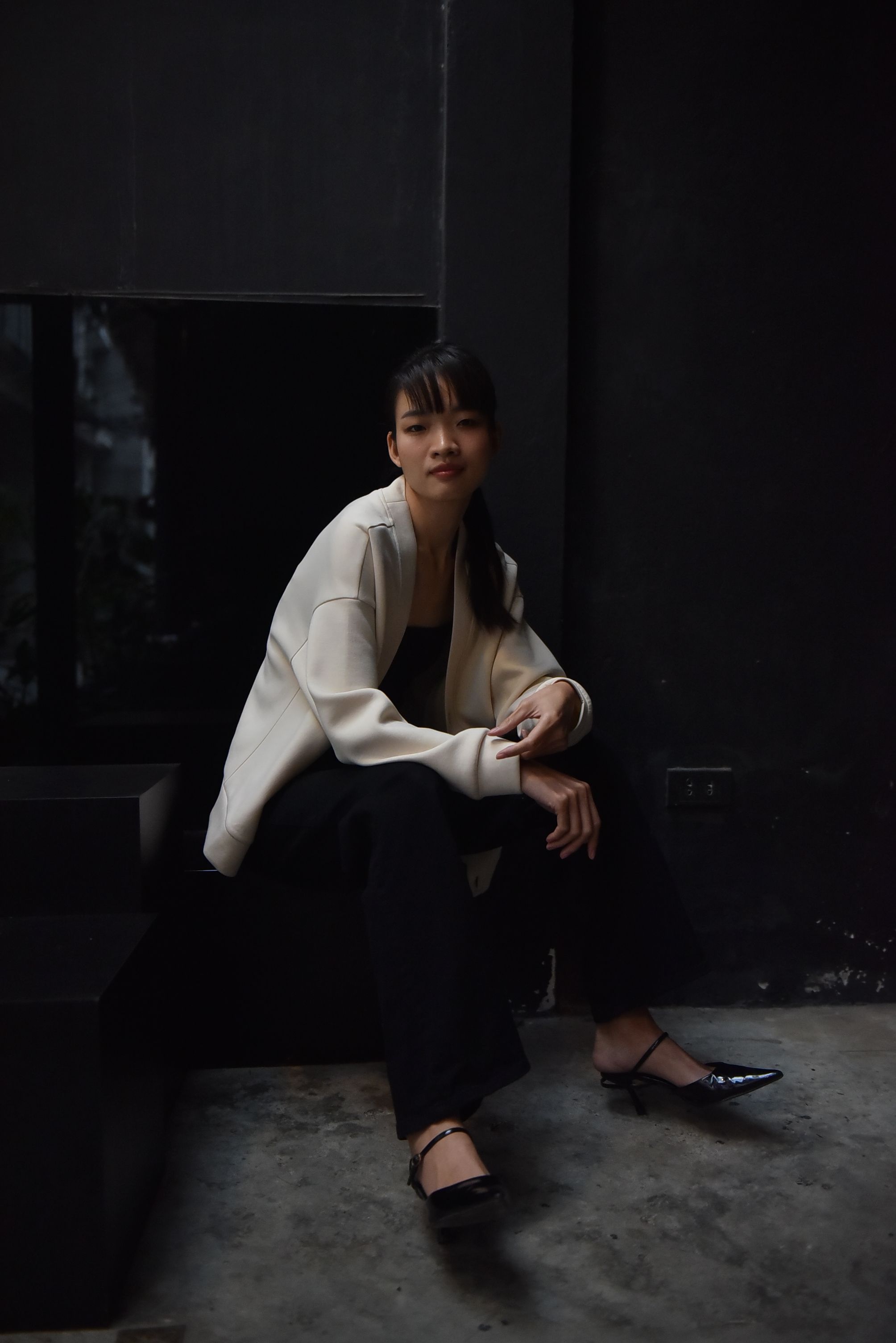 Contemplative Woman in Minimalist Setting · Free Stock Photo