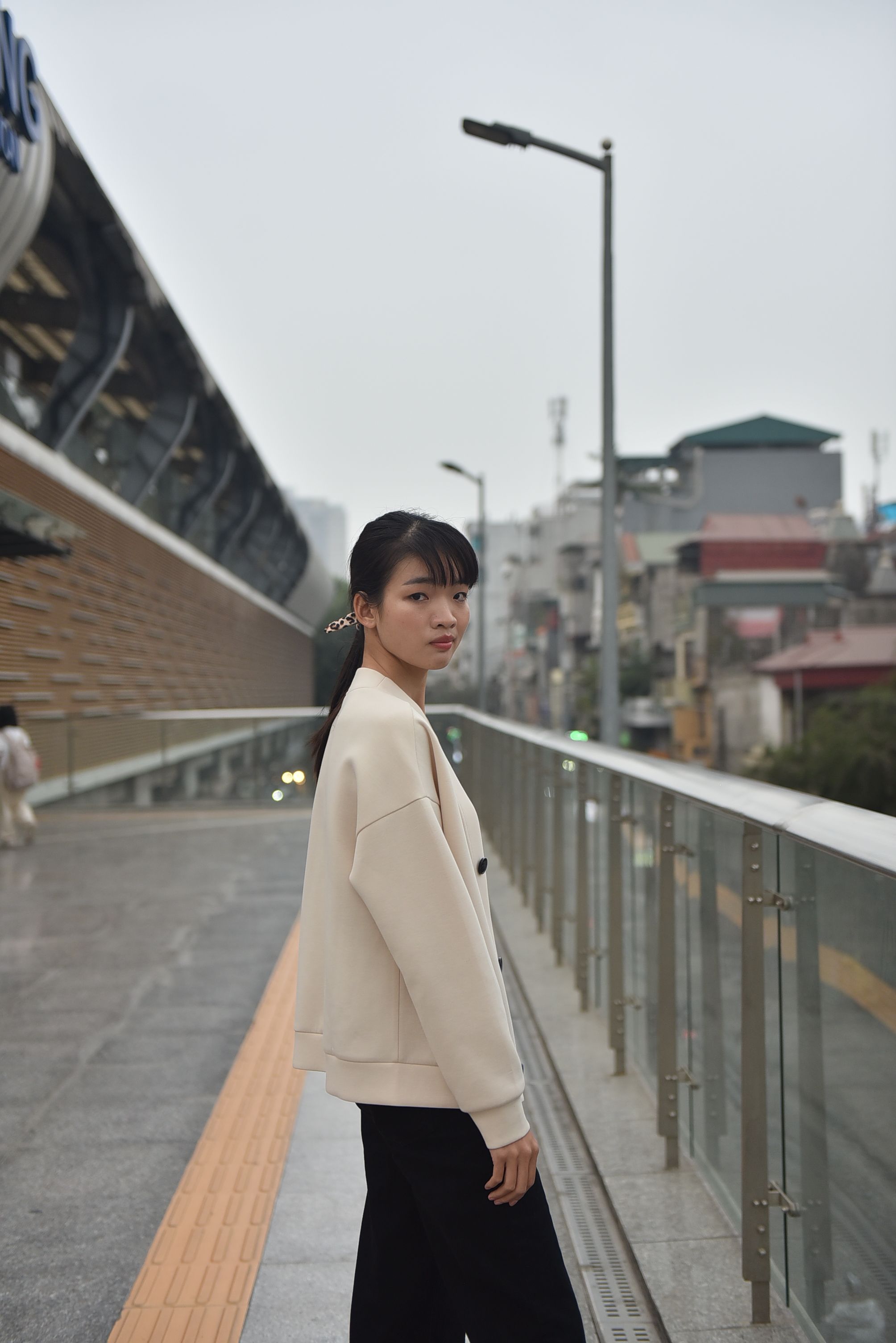 Young Woman Posing on Modern City Bridge · Free Stock Photo