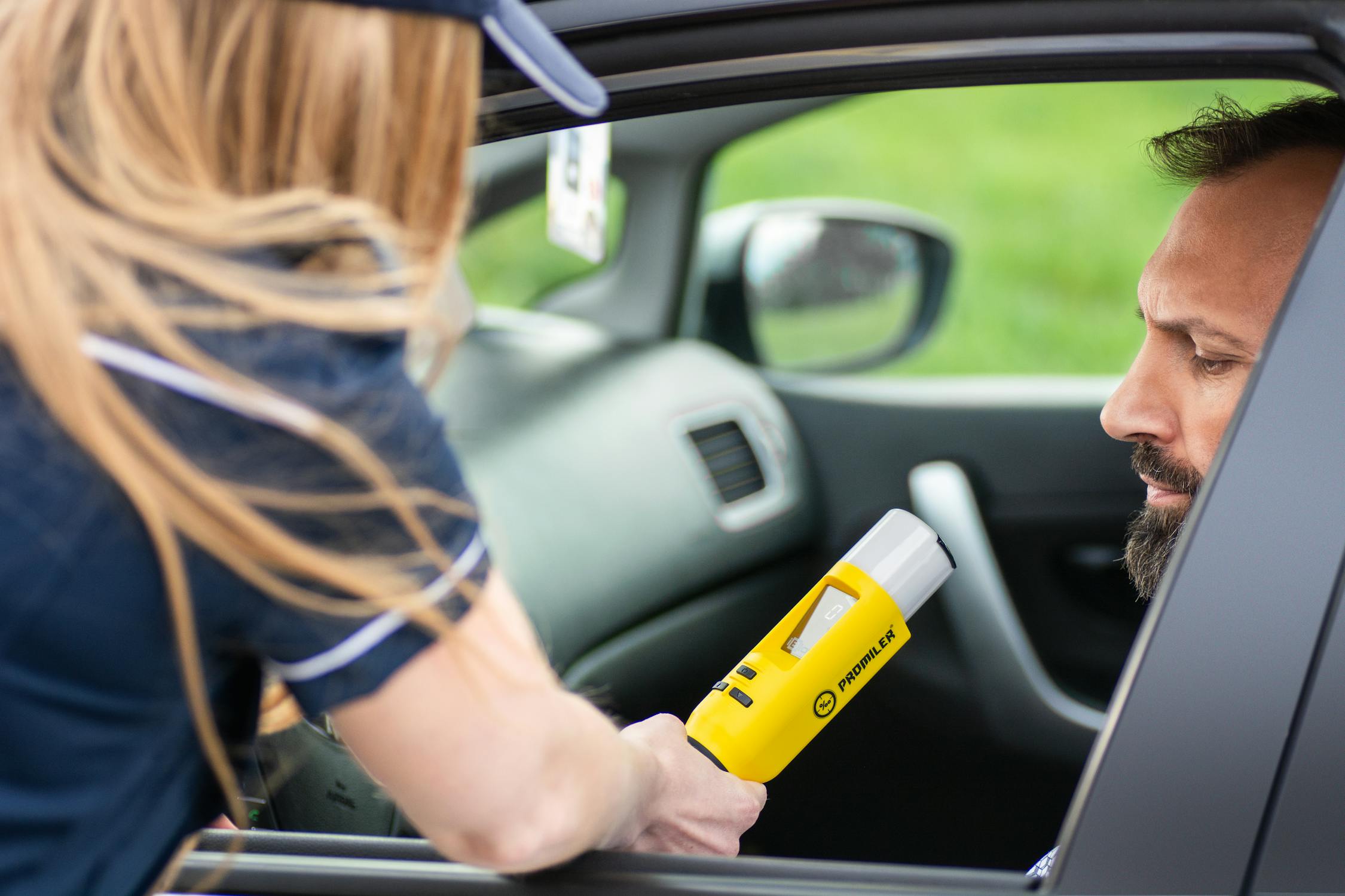 Police Officer Conducting Breathalyzer Test in Car