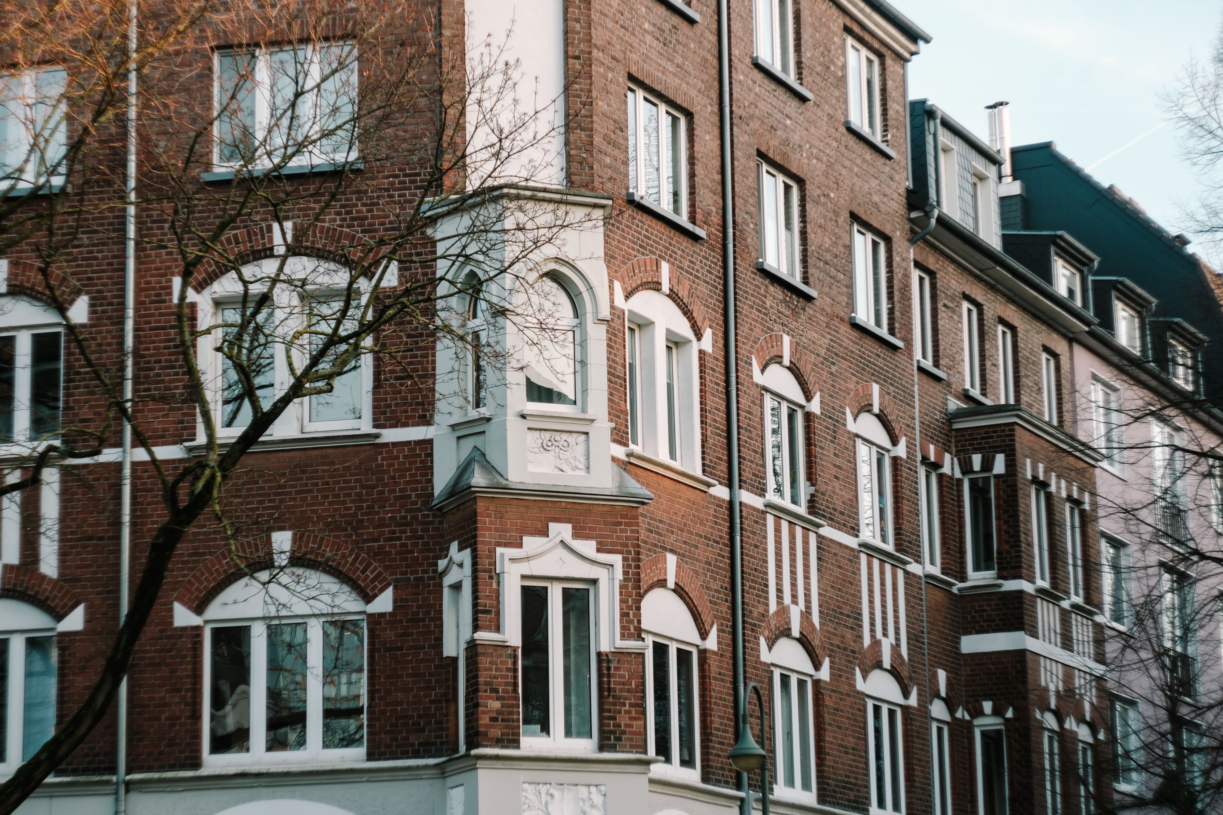 Charming brick facade of a historic residential building in Düsseldorf's urban setting.