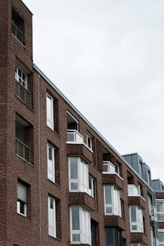 Contemporary brick apartment building exterior in Düsseldorf, displaying urban architecture.