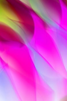 A colorful abstract image with flowing pink and green light patterns.