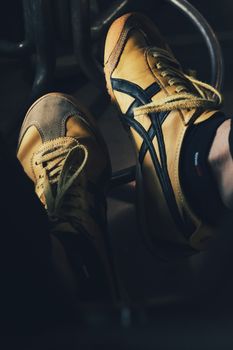 Stylish vintage yellow sneakers with black stripes, showcasing classic footwear design.