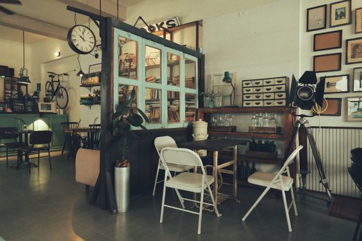 Charming cafe interior featuring vintage decor, old books, and retro furniture for a nostalgic ambiance.