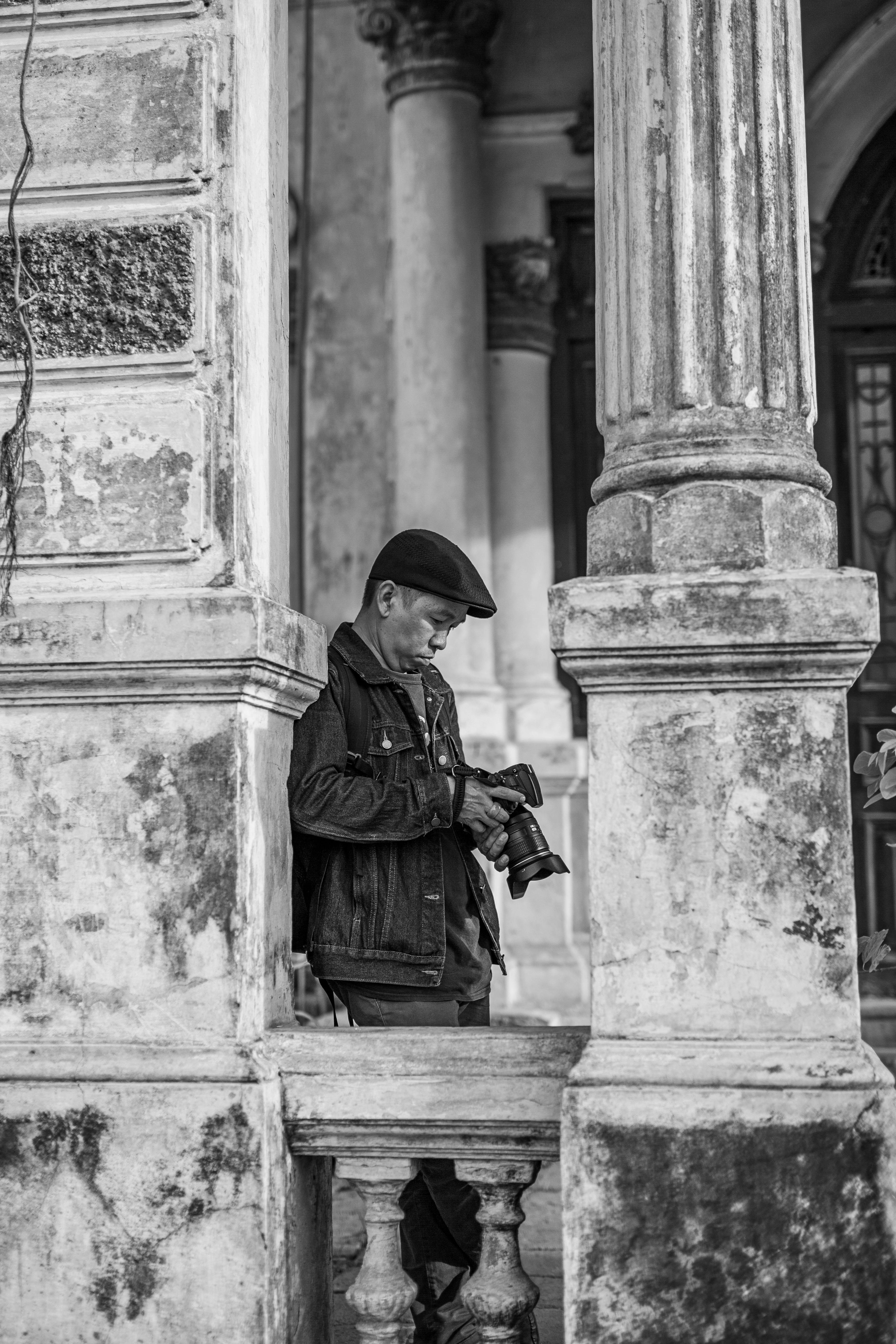 Timeless black and white image of a photographer in a vintage setting.