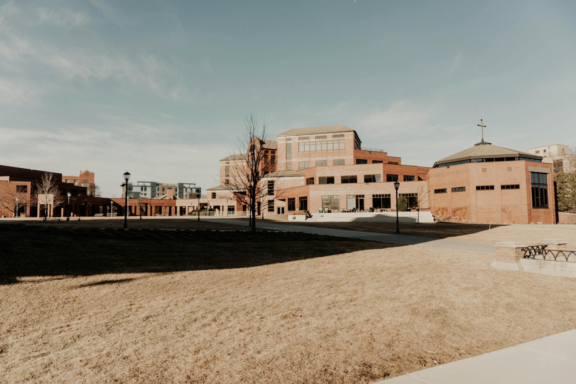 A wide-angle view of modern brick buildings in Milwaukee under a clear sky.