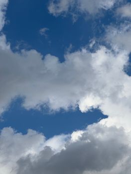 A breathtaking view of a clear blue sky adorned with fluffy white clouds.