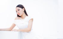 Elegant Woman in White Dress with Pearls