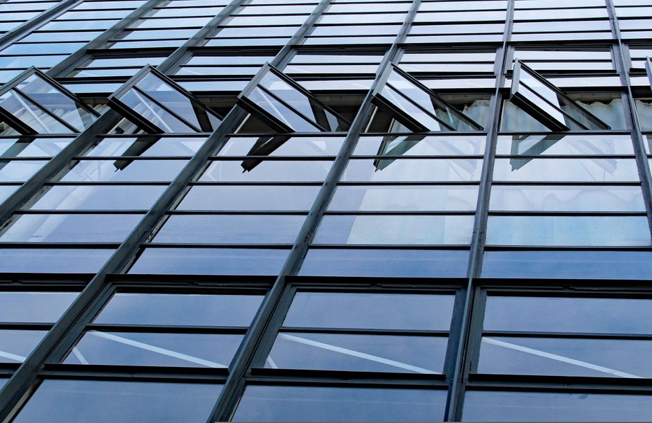 Angled glass curtain wall with a regular grid of aluminium mullions