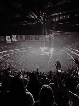 Black and white photo of a lively concert crowd inside an arena in Tulsa, Oklahoma.