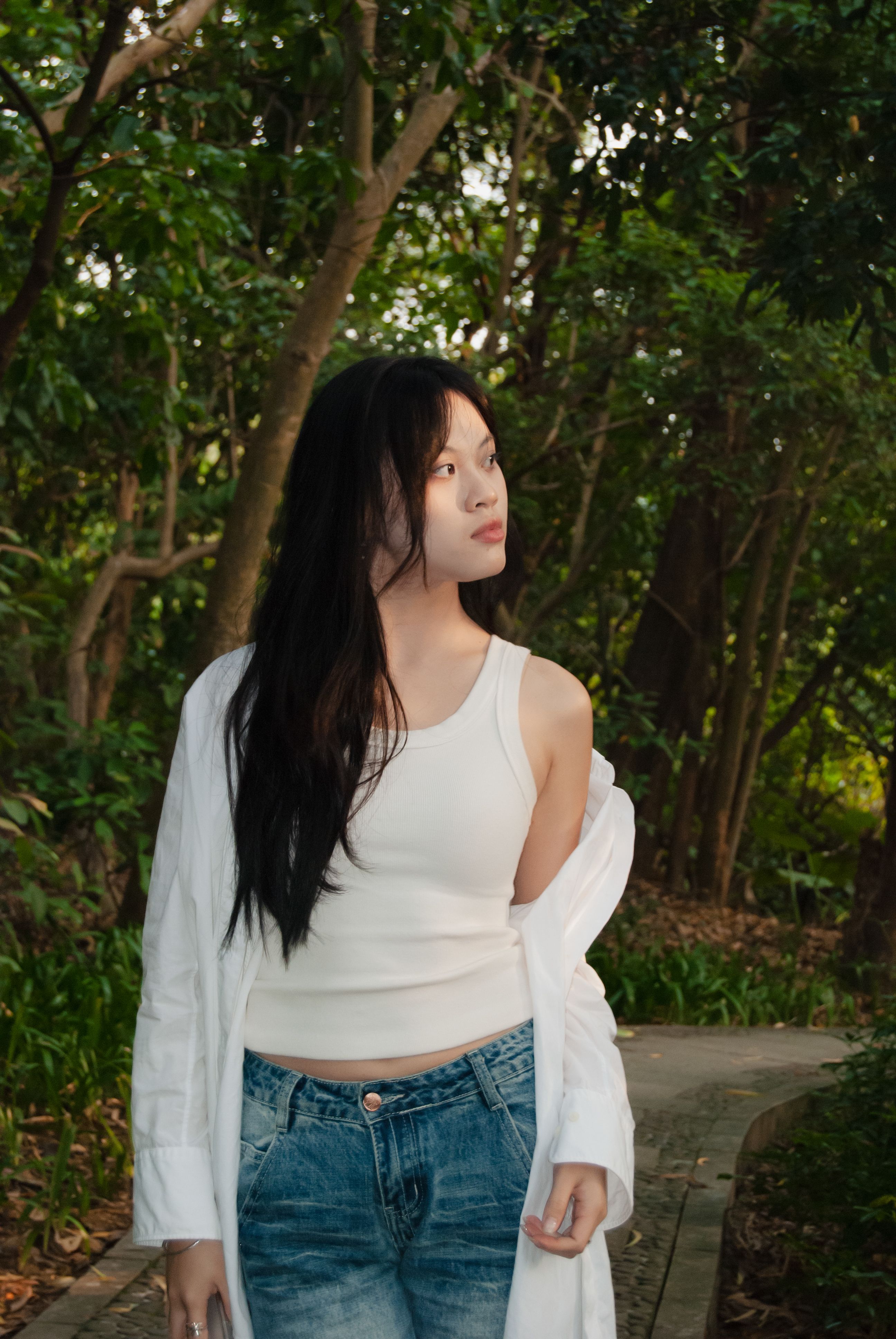 Young Woman Strolling in a Lush Green Forest · Free Stock Photo