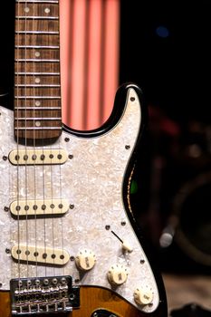 Detailed electric guitar capture in warm indoor lighting setting.