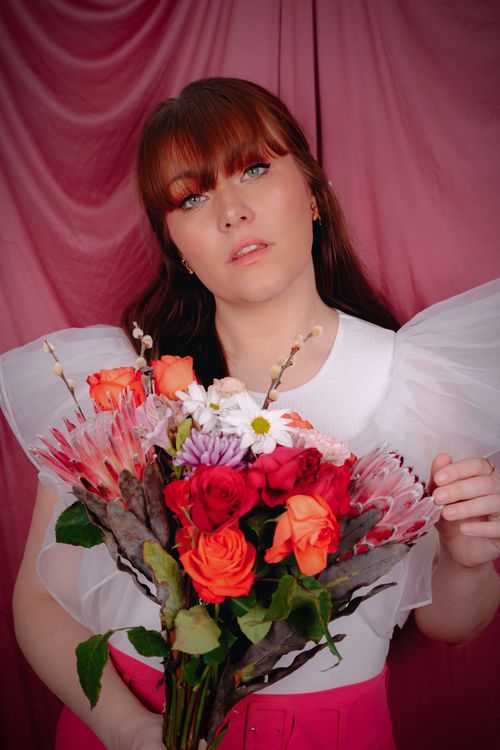 Free A vibrant spring portrait featuring floral fashion and creative photography style. Stock Photo