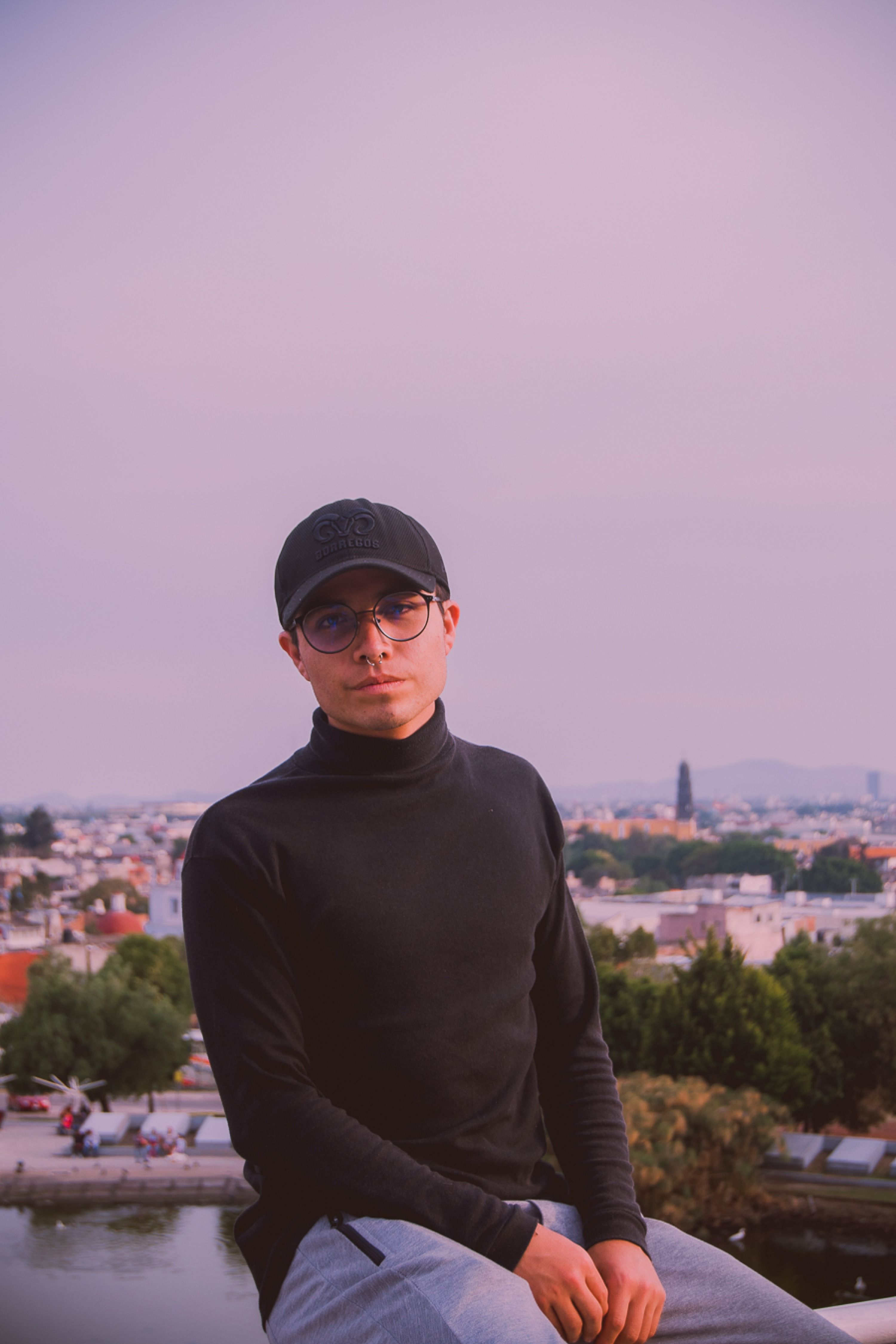 Stylish young man in urban setting with cityscape background