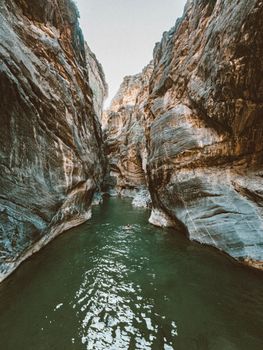 Explore the stunning rock formations and emerald waters of Snake Canyon, Oman.