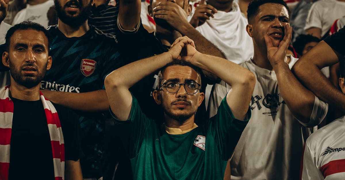 Energetic crowd of football fans showing emotions during a live match.
