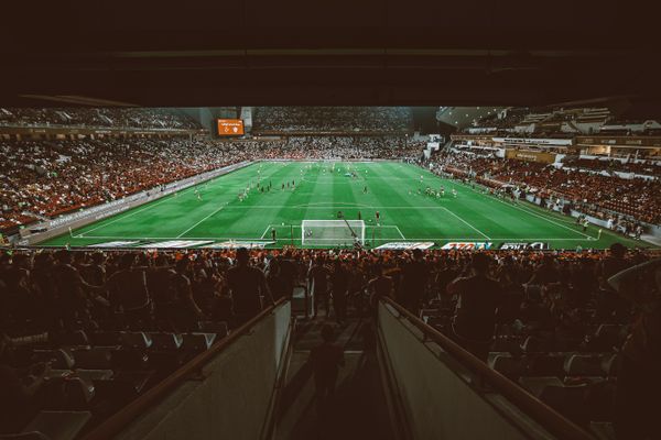 Aerial shot of a football match in a packed stadium