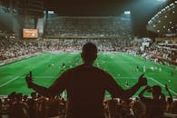 Football Fans Cheering in Stadium at Night