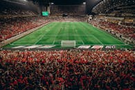 Vibrant Football Match at Night Stadium