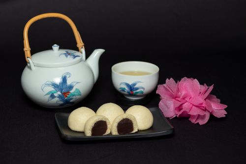 Free Traditional Chinese tea ceremony set with teapot and sweets over black background. Stock Photo