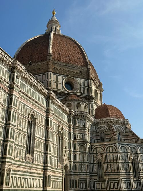 Free Iconic view of the Florence Cathedral with its stunning dome under a clear blue sky. Stock Photo